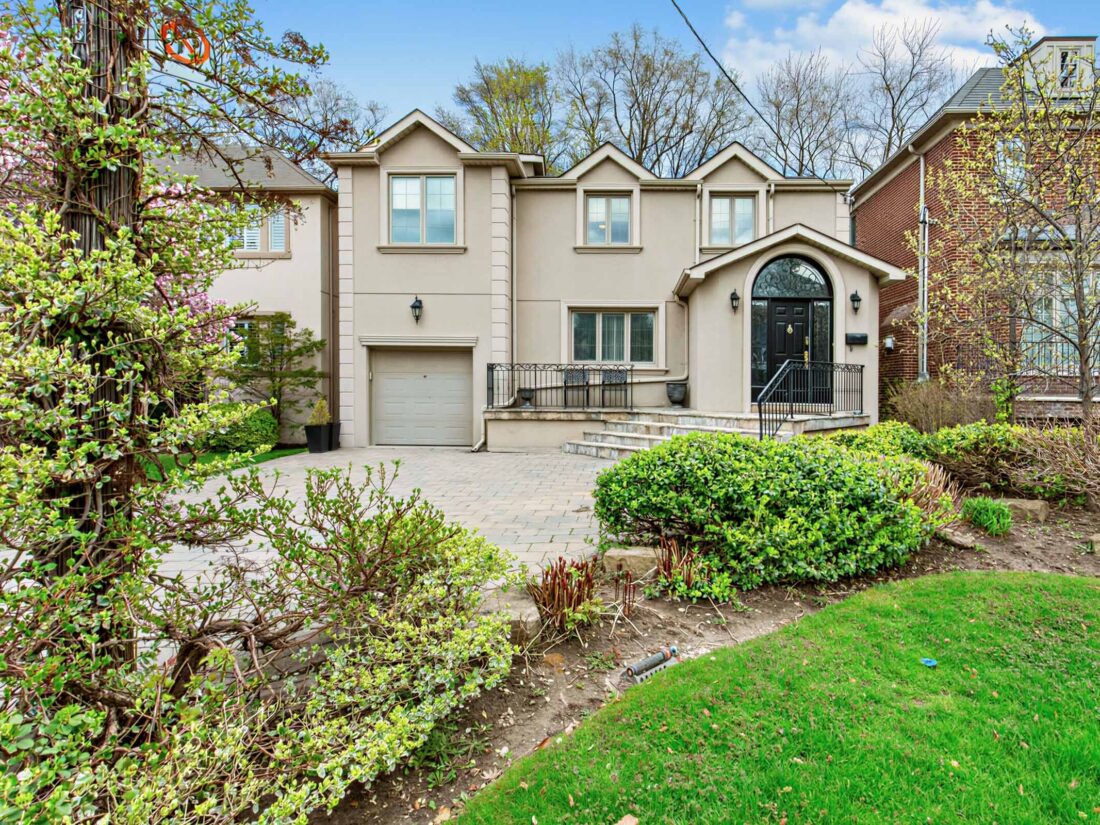 85 Westgate Blvd - stucco two-storey home with an arched entry and an attached garage.