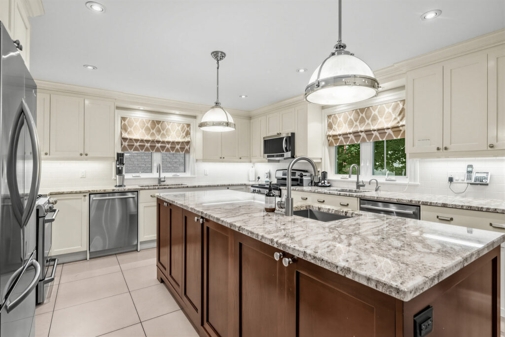 A renovated eat-in kitchen with a granite island, in a home sold on the Bathurst corridor
